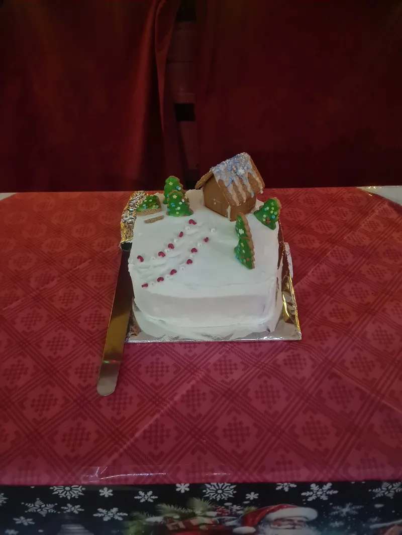 The Christmas cake on a table with a red tablecloth