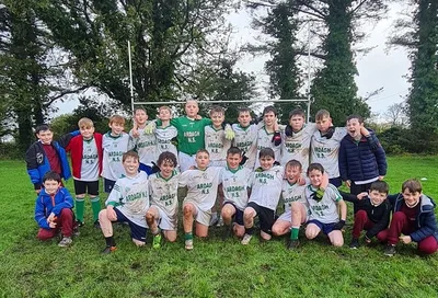 A school team photo on a playing pitch