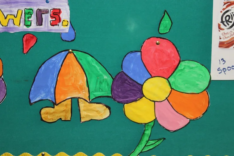 A painted Green Schools display with an umbrella and a flower