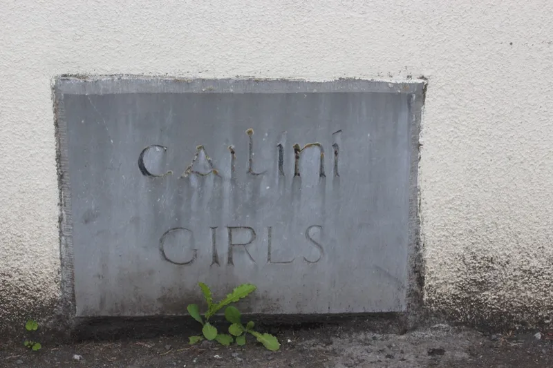 Carved stone over the old girls' entrance, reading Cailíní and Girls